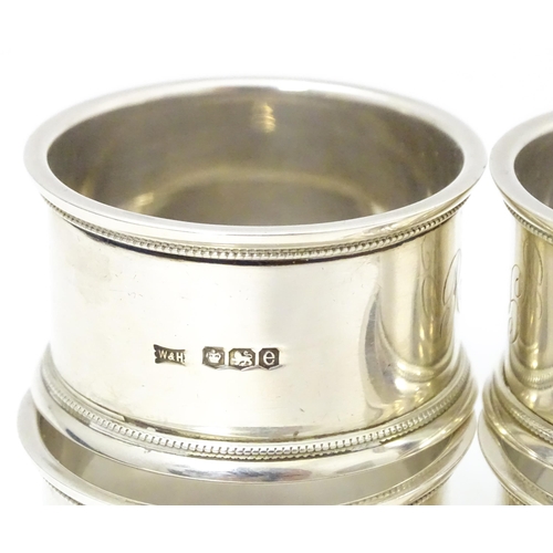 603 - A cased set of 4 silver napkin rings hallmarked Sheffield 1922 maker Walker & Hall.