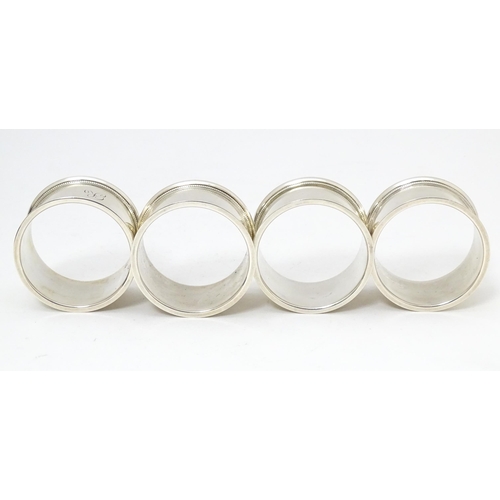 603 - A cased set of 4 silver napkin rings hallmarked Sheffield 1922 maker Walker & Hall.