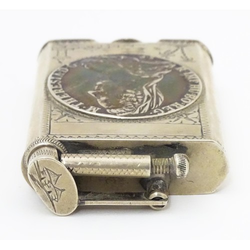 1195 - A pocket lighter, engraved with native scenes and inset with Thaler coin style detail, approx 2 7/8