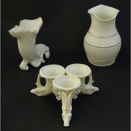 140 - Two items of Belleek comprising a cornucopia spill vase and blush pink vase with shaped rim. Marked ... 