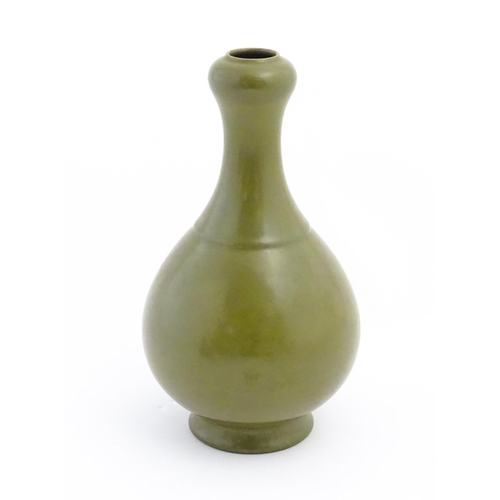 19 - A Chinese bottle vase with tea coloured glaze. Character marks under. Approx. 11