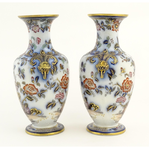 199 - A pair of Oriental baluster vases with twin stylised animal mask handles, decorated in the Imari pal... 