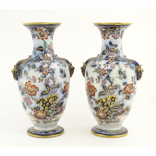 199 - A pair of Oriental baluster vases with twin stylised animal mask handles, decorated in the Imari pal... 