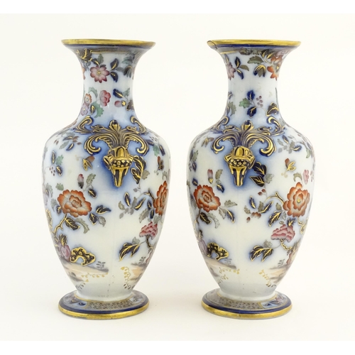 199 - A pair of Oriental baluster vases with twin stylised animal mask handles, decorated in the Imari pal... 