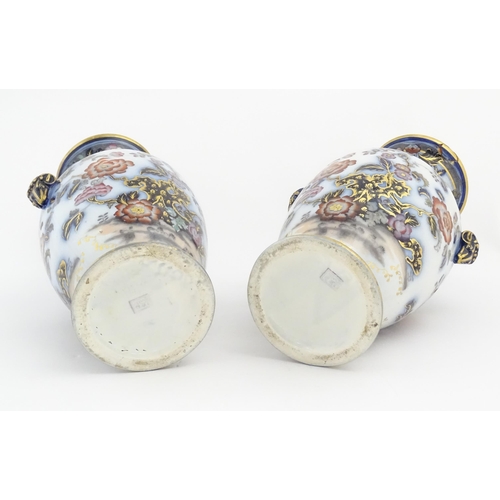 199 - A pair of Oriental baluster vases with twin stylised animal mask handles, decorated in the Imari pal... 