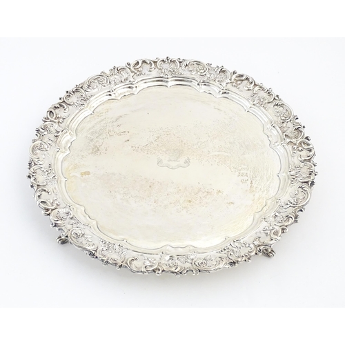 437 - An exceptionally large silver salver with acanthus scroll floral and foliate detail to border, havin... 