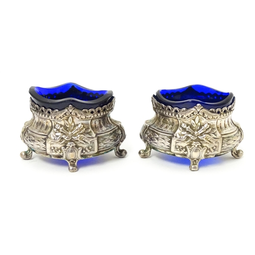 604 - A pair of silver salts with blue glass liners with import marks for London 1901, importer D Pennelli... 