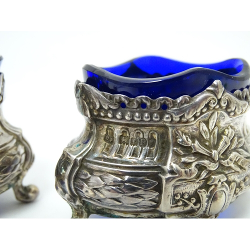 604 - A pair of silver salts with blue glass liners with import marks for London 1901, importer D Pennelli... 