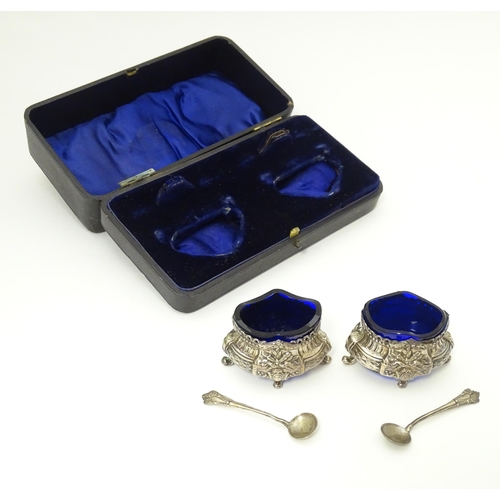 604 - A pair of silver salts with blue glass liners with import marks for London 1901, importer D Pennelli... 