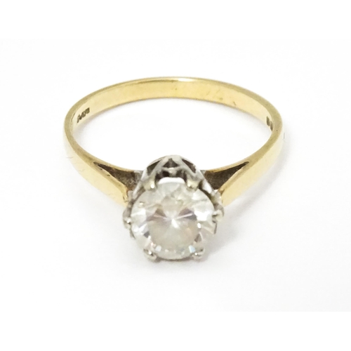 642 - A 9ct gold solitaire ring set with white stone. Ring size approx. K 1/2