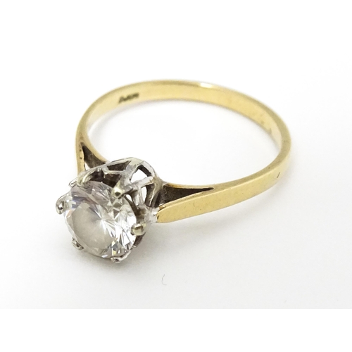 642 - A 9ct gold solitaire ring set with white stone. Ring size approx. K 1/2