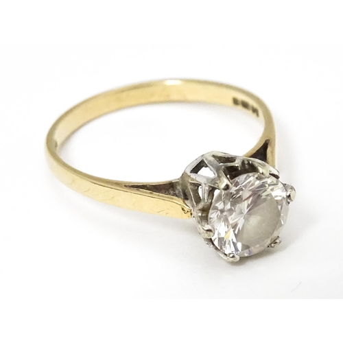 642 - A 9ct gold solitaire ring set with white stone. Ring size approx. K 1/2