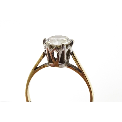 642 - A 9ct gold solitaire ring set with white stone. Ring size approx. K 1/2