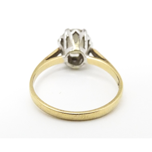 642 - A 9ct gold solitaire ring set with white stone. Ring size approx. K 1/2