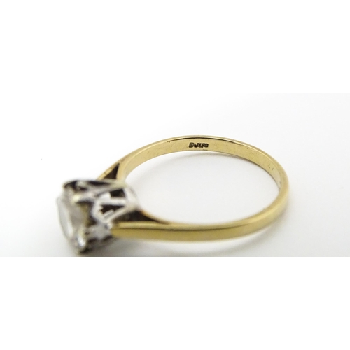 642 - A 9ct gold solitaire ring set with white stone. Ring size approx. K 1/2