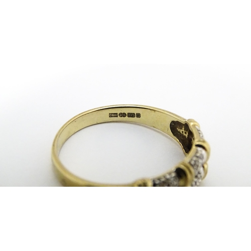 644 - A 9ct gold ring having double band detail with six segments each set with four diamonds. Ring size a... 