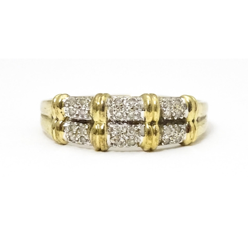 644 - A 9ct gold ring having double band detail with six segments each set with four diamonds. Ring size a... 