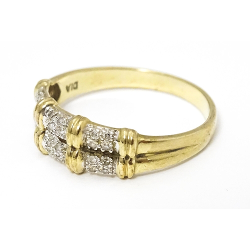 644 - A 9ct gold ring having double band detail with six segments each set with four diamonds. Ring size a... 