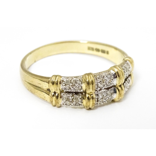 644 - A 9ct gold ring having double band detail with six segments each set with four diamonds. Ring size a... 