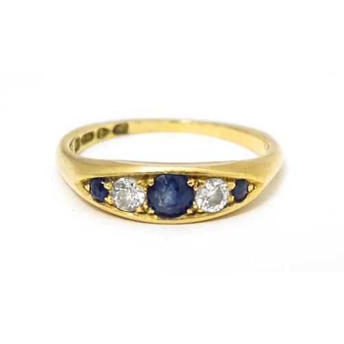 645 - An 18ct gold ring set with sapphires and diamonds and hallmarked  Chester 1909 maker B H Joseph & Co... 