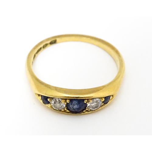 645 - An 18ct gold ring set with sapphires and diamonds and hallmarked  Chester 1909 maker B H Joseph & Co... 