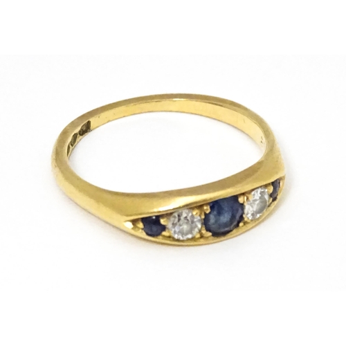 645 - An 18ct gold ring set with sapphires and diamonds and hallmarked  Chester 1909 maker B H Joseph & Co... 