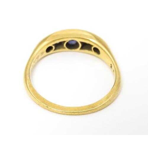 645 - An 18ct gold ring set with sapphires and diamonds and hallmarked  Chester 1909 maker B H Joseph & Co... 