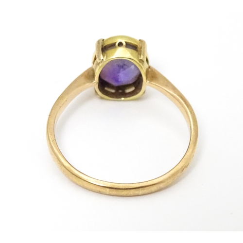 646 - A 9ct gold ring set with oval amethyst in a claw setting. Ring size approx. P 1/2