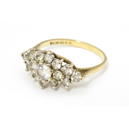 649 - A 9ct gold ring set with cluster of white stones. Ring size approx. J 1/2