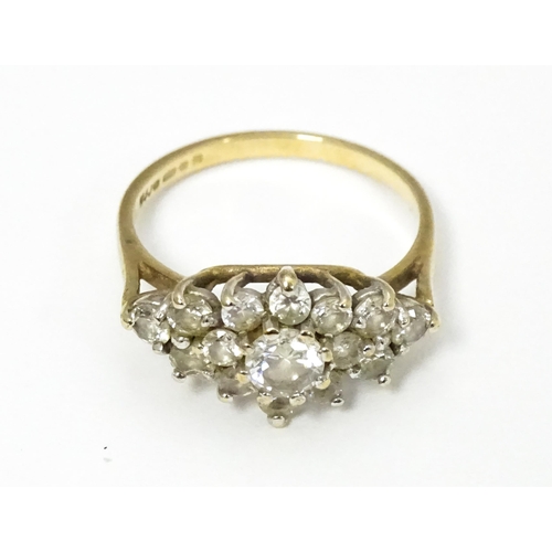 649 - A 9ct gold ring set with cluster of white stones. Ring size approx. J 1/2