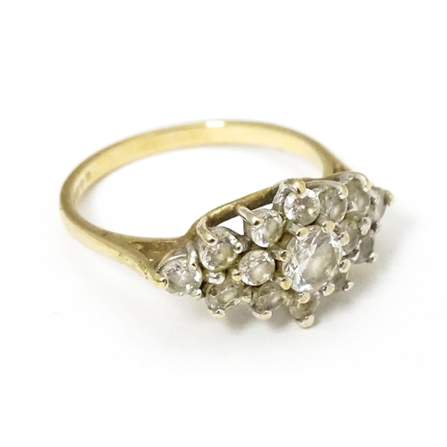 649 - A 9ct gold ring set with cluster of white stones. Ring size approx. J 1/2