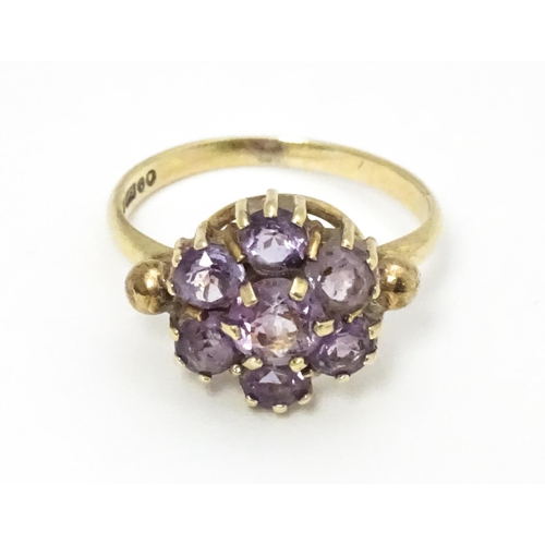 651 - A 9ct gold ring set with with amethyst cluster. Ring size approx. L 1/2