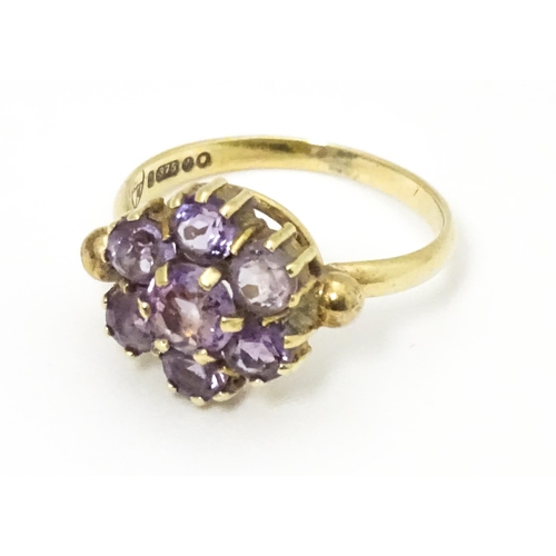 651 - A 9ct gold ring set with with amethyst cluster. Ring size approx. L 1/2