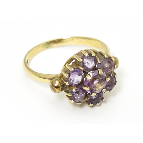 651 - A 9ct gold ring set with with amethyst cluster. Ring size approx. L 1/2