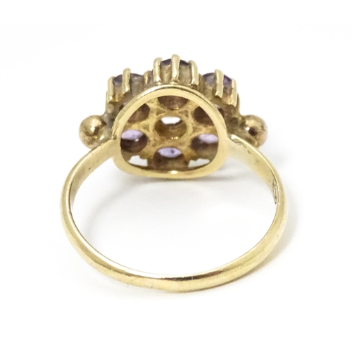 651 - A 9ct gold ring set with with amethyst cluster. Ring size approx. L 1/2