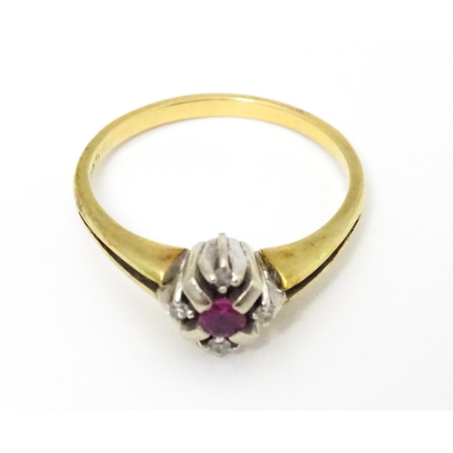 654 - A 14ct gold ring set with central ruby bordered by four diamonds. Ring size approx. Q