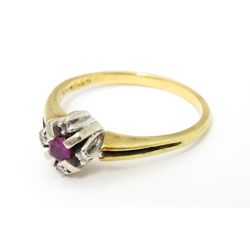 654 - A 14ct gold ring set with central ruby bordered by four diamonds. Ring size approx. Q