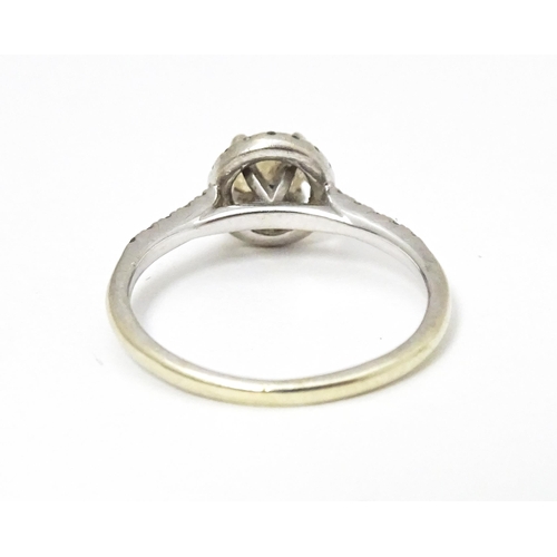 660 - A 9ct white gold ring set with central citrine coloured stone bordered by diamonds and with further ... 