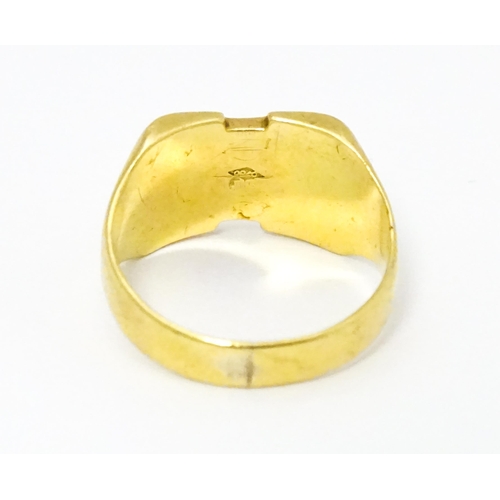 663 - An 18ct gold signet ring. Ring size approx H