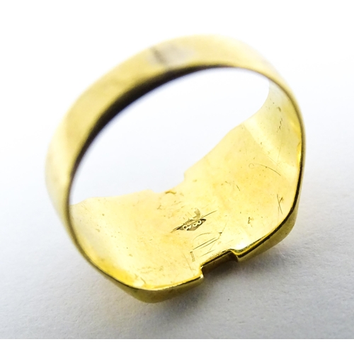 663 - An 18ct gold signet ring. Ring size approx H