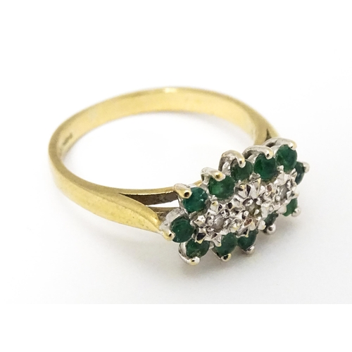 665 - A 9ct gold ring set with emeralds and diamonds. Ring size approx K 1/2