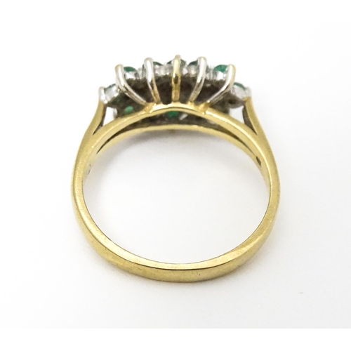 665 - A 9ct gold ring set with emeralds and diamonds. Ring size approx K 1/2