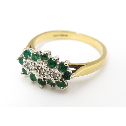 665 - A 9ct gold ring set with emeralds and diamonds. Ring size approx K 1/2