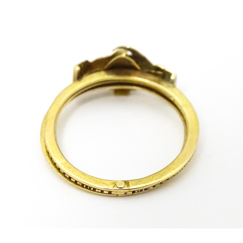 668 - A yellow metal gimmal / gimmel ring the three bands uniting as one, with a pair of interlocking hand... 