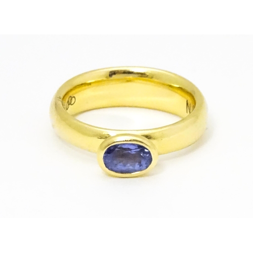 672 - An 18ct gold ring set with oval tanzanite, maker Links of London. Ring size approx M