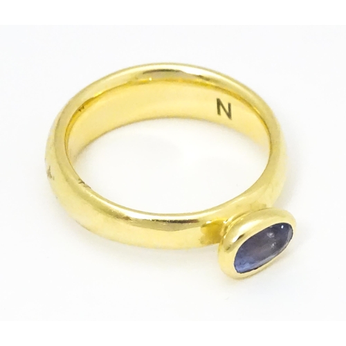 672 - An 18ct gold ring set with oval tanzanite, maker Links of London. Ring size approx M