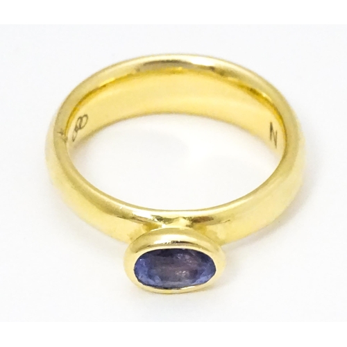 672 - An 18ct gold ring set with oval tanzanite, maker Links of London. Ring size approx M