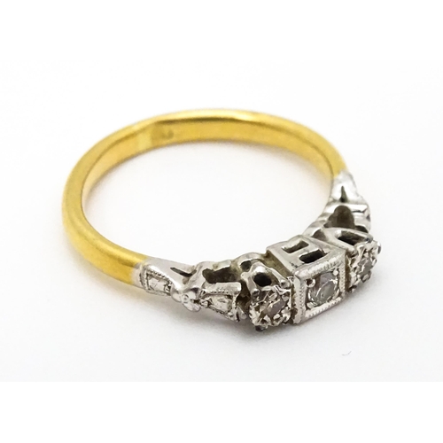 675 - A gold ring set with trio of diamonds. Ring size approx. H 1/2