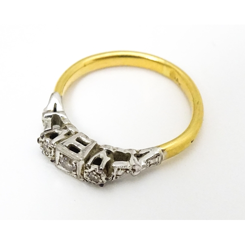 675 - A gold ring set with trio of diamonds. Ring size approx. H 1/2