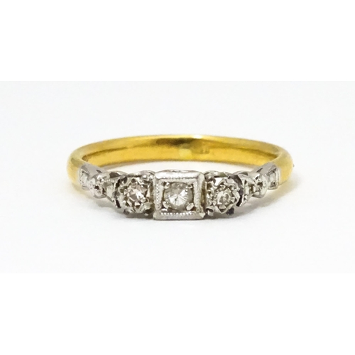 675 - A gold ring set with trio of diamonds. Ring size approx. H 1/2